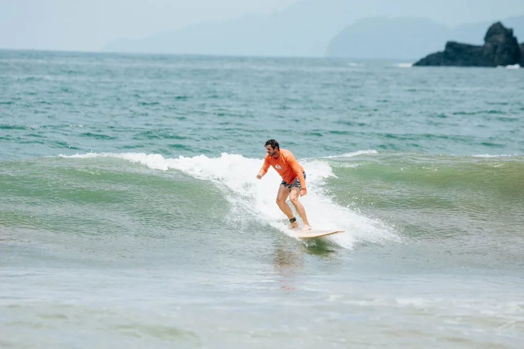 A guy riding the waves while surfing at Alaya Panama