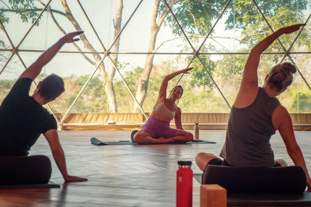 A yoga instructor guiding a class at Alaya Panama, creating a peaceful and mindful environment for relaxation and wellness.