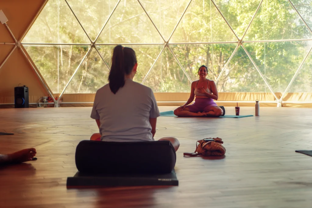 A yoga instructor guiding a class at Alaya Panama