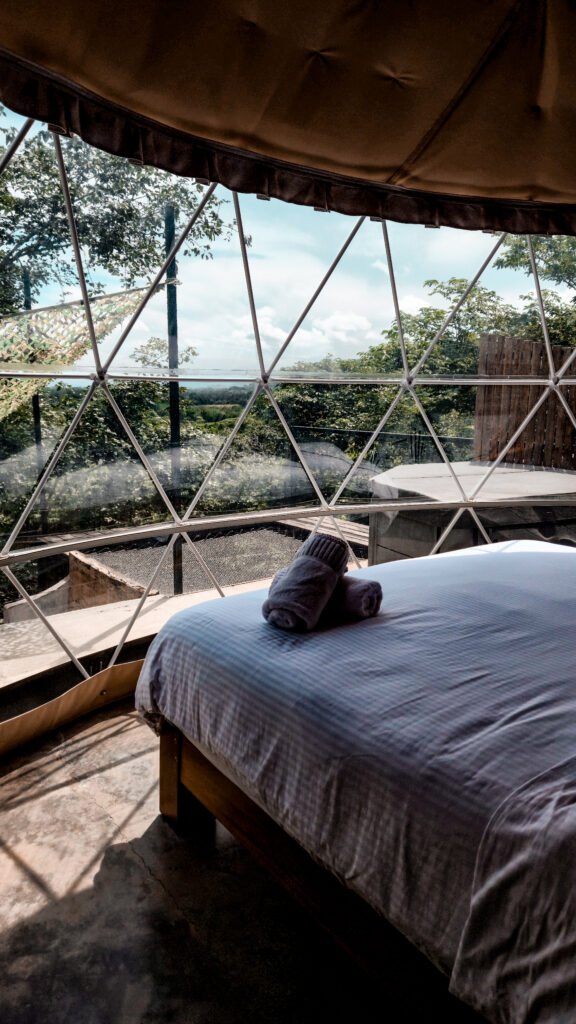 How to Plan a Group Retreat in Panama: A Guide for Retreat Leaders 3 Bed beside panoramic windows inside a dome at Alaya Panama