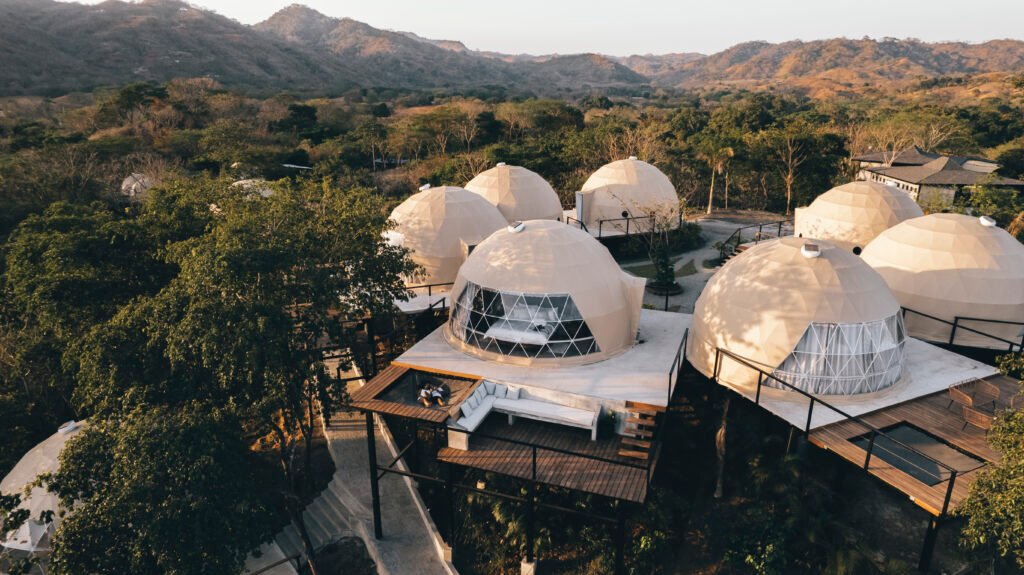 How to Plan a Group Retreat in Panama: A Guide for Retreat Leaders 1 Aerial view of Alaya Panama’s domes surrounded by trees and hills